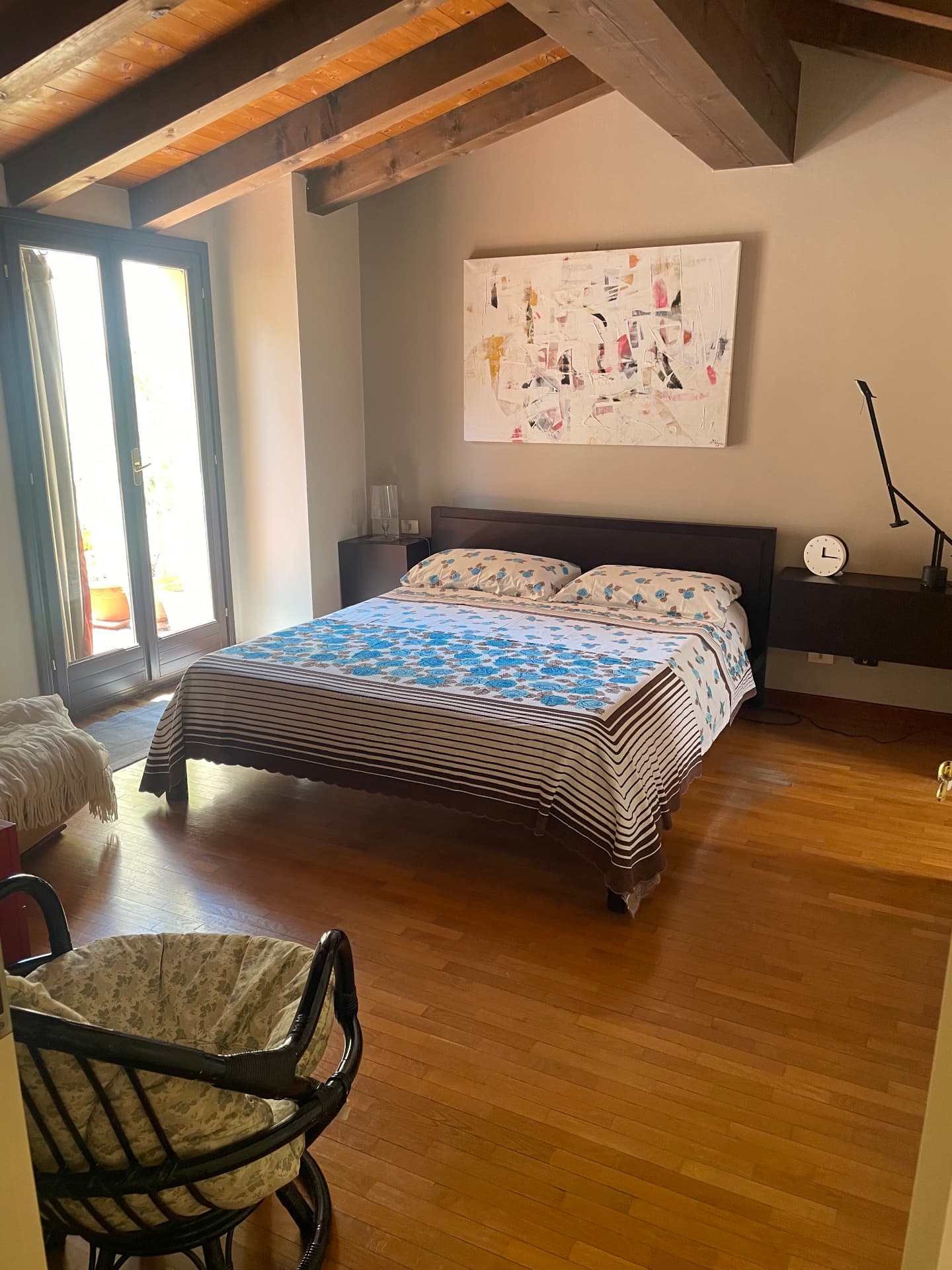 Main bedroom with double bed, abstract painting and French doors onto the terrace